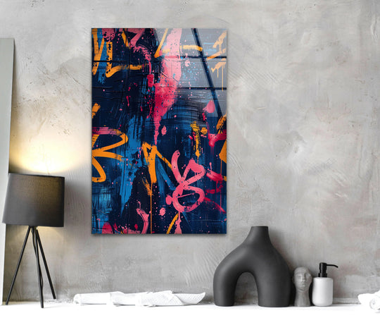 Blue street graffiti glass wall art features bright pink and orange accents against a dark navy background on these cool wall prints.