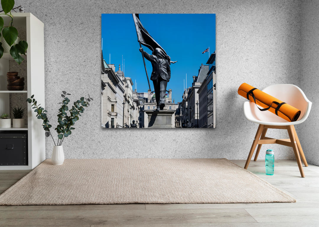 A soft beige textured rug lies over light wooden planks in the foreground, leading to a striking Banksy-inspired glass art piece.