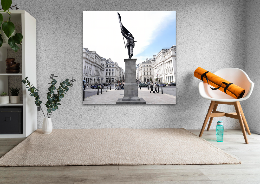 The smooth, brilliant finish of this Banksy wall art print captures a dynamic city square with its monument of motion and classic urban buildings.