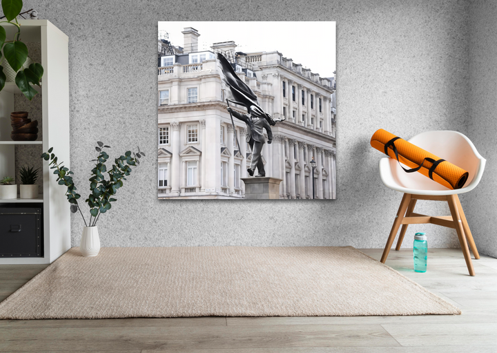 Clean negative space beautifully frames a captivating Banksy statue in London glass art painting, emphasizing its urban elegance.