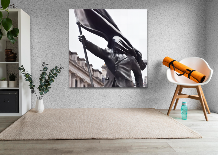 The transition between the statue's deep charcoal tones and the pale sky in this Banksy Flag Bearer glass art painting is striking.