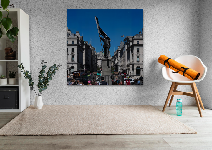 The pronounced color contrast between the dark urban statue, black flag, and vivid blue sky creates a powerful Banksy glass art statement.