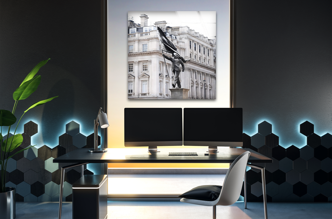 Highlighting strong color contrast, the bright Banksy Statue in London print wall art stands against a dark room with blue and yellow ambient lighting.