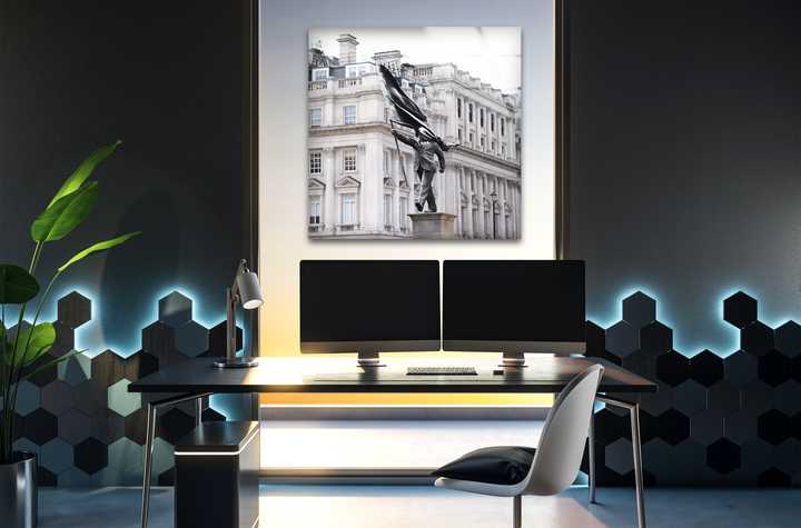 Highlighting strong color contrast, the bright Banksy Statue in London print wall art stands against a dark room with blue and yellow ambient lighting.