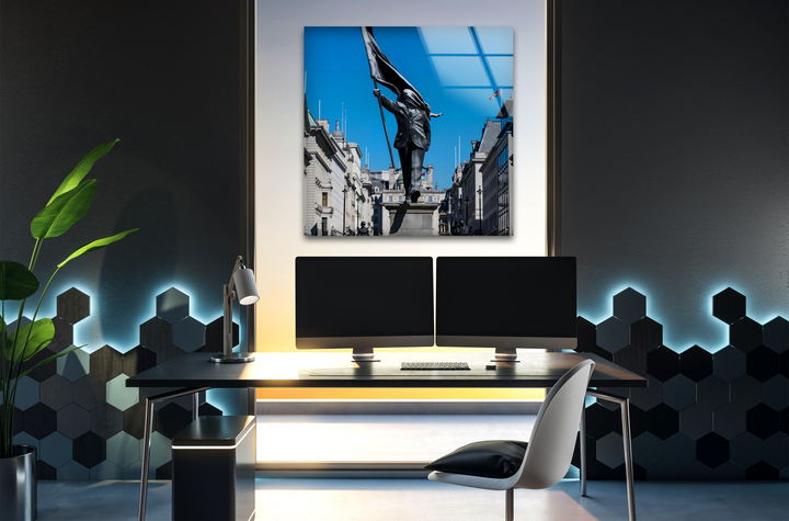 The realistic detail of a vibrant Banksy Freedom March Statue under an azure blue sky is exquisitely captured in this glass printing.