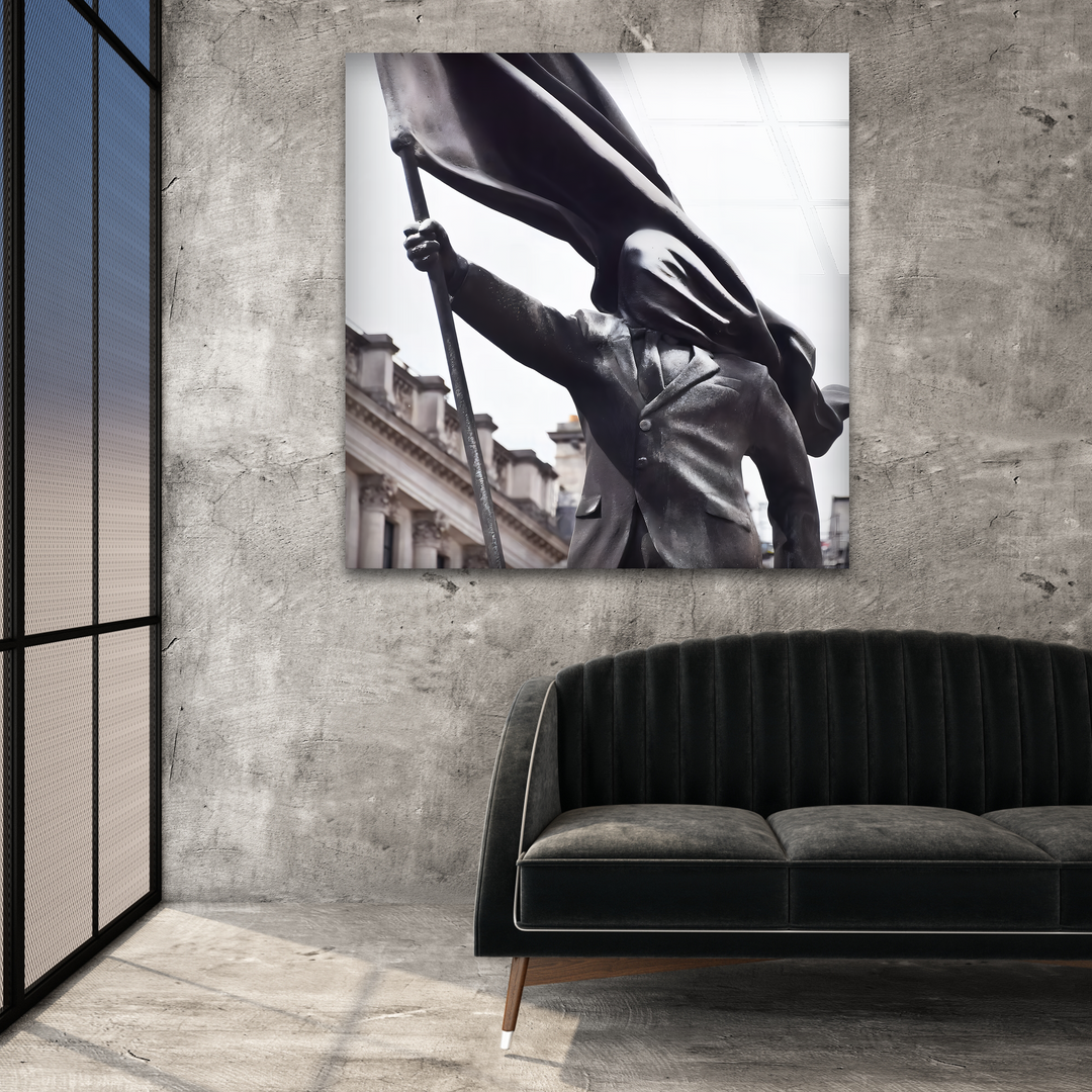 The dynamic sense of movement in this Banksy Flag Bearer glass wall art decor is conveyed by the flowing flag and resolute statue.