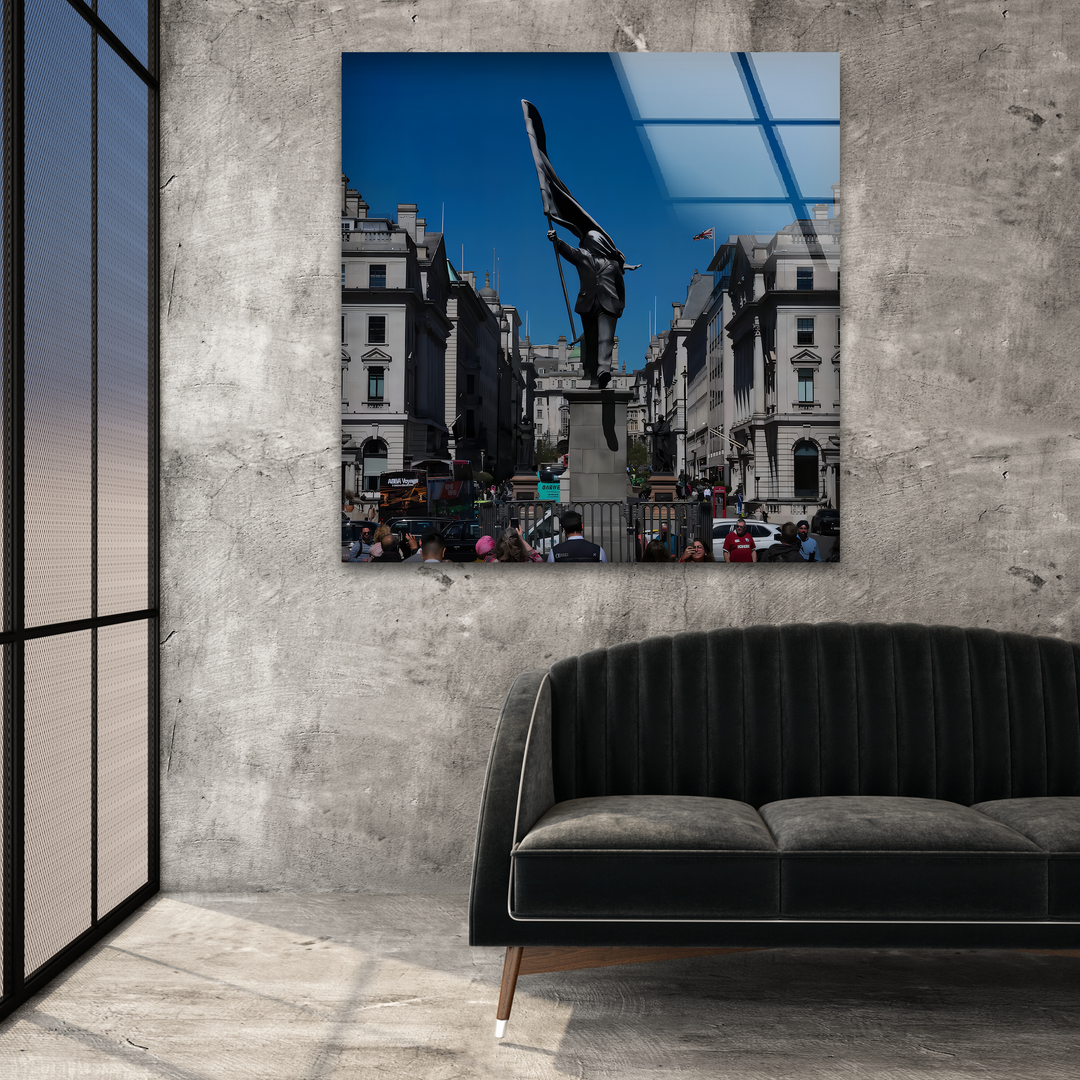 The stark silhouette of the flag-bearer in the London Banksy glass wall art prints casts a powerful, dark presence in the room.