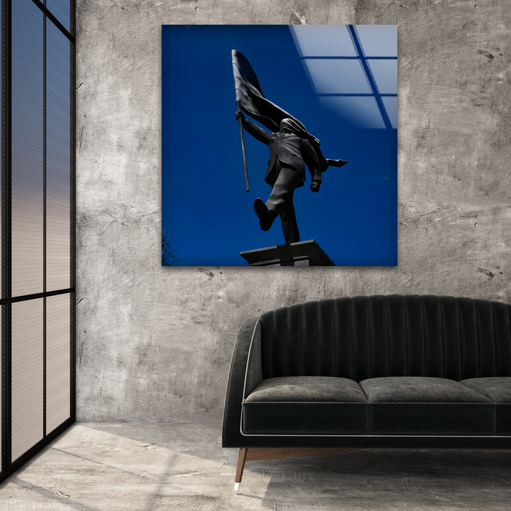 A striking Banksy flag bearer statue, a silhouetted figure against a deep blue sky, makes a bold statement in home decor.