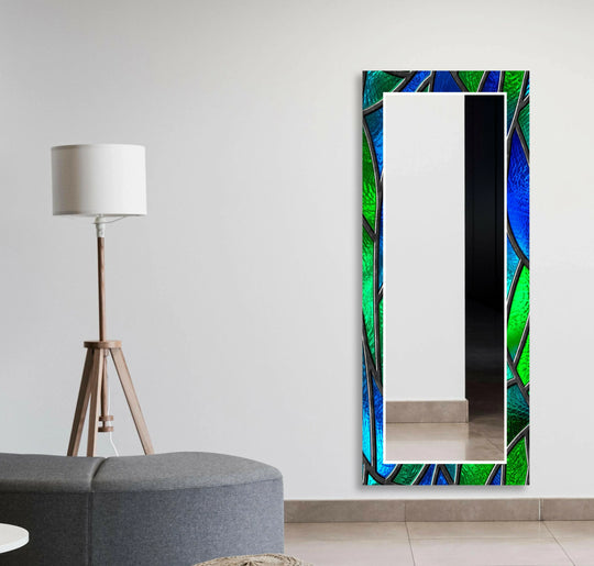 A long mirror features a stunning abstract green and blue stained glass look design perfect for unique artistic decor on a white wall