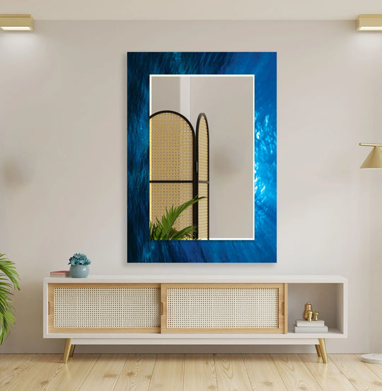 Large wall mirror featuring a deep sea appearance blue design and an abstract oceanic motif reflecting an interior room