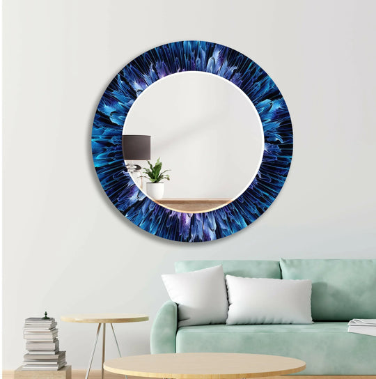 Blue Bathroom Wall Mirror a round modern decorative mirror with vibrant blue and purple abstract patterns on a white wall
