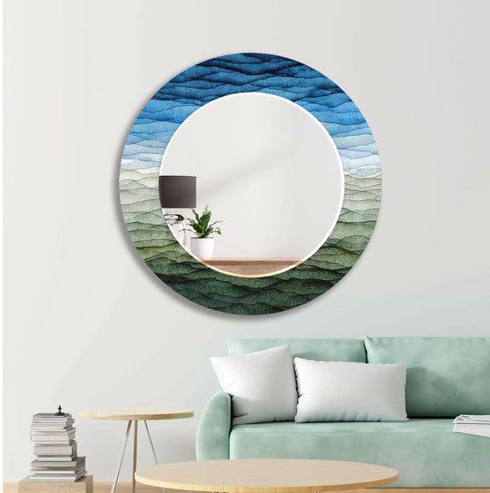 Decorative Wall Mirrors round featuring blue and green waves and a nature inspired abstract design on a white wall