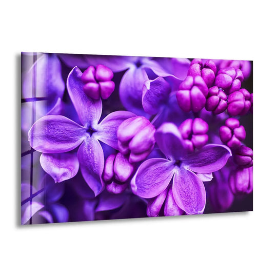 Close-up of vibrant purple lilac blooms on tempered glass wall art, with a subtle layering effect and soft background blur.