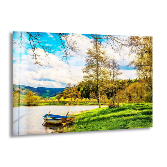 Tranquil riverside boat scene captured on glass wall art, featuring lush greenery and a peaceful water reflection.

