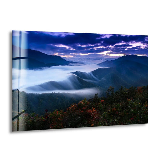 The foggy landscape and misty mountain sunrise, a stunning glass wall artwork, serves as the central subject and evokes a sense of breathtaking serenity.