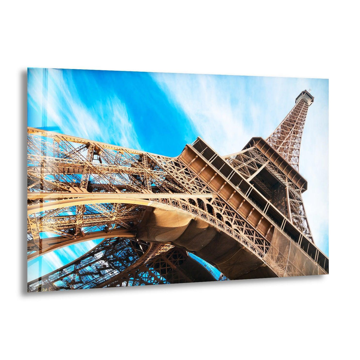 Vertically oriented and rectangular, the Eiffel Tower glass printing art piece showcases a close-up of the Parisian icon against a vibrant blue sky.