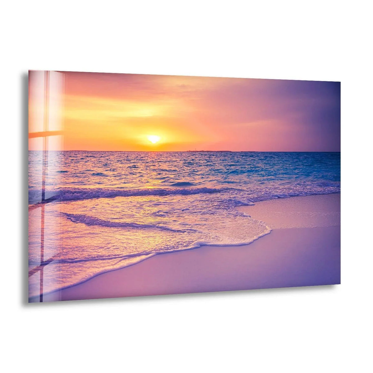 Warm hues of orange and yellow dominate the sunset in this empty beach glass wall prints, contrasting with the cooler blues of the ocean.