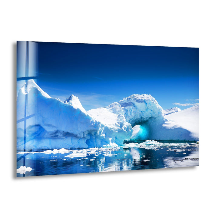Majestic Arctic iceberg floating on crystal-clear waters, printed on glass wall art.
