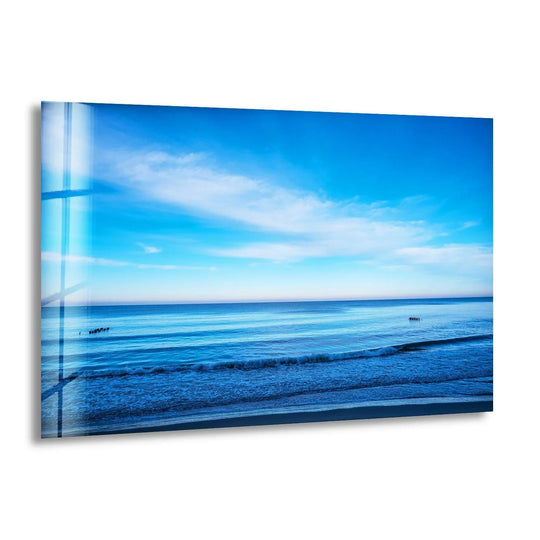 Bathed in the sky's radiant glow, this tranquil ocean horizon features serene art from glass, capturing the brilliant luminescence above the calm sea.