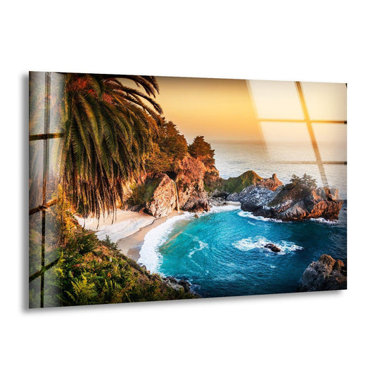 Highlighting the focal point, the glass wall art features a stunning tropical paradise cove with turquoise waters, embodying the best glass art coastal escape.