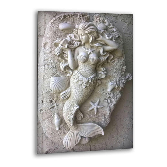 A vertical tempered glass wall art showcases a serene mermaid sculpture with flowing hair and a fish-like tail on a textured rock surface.