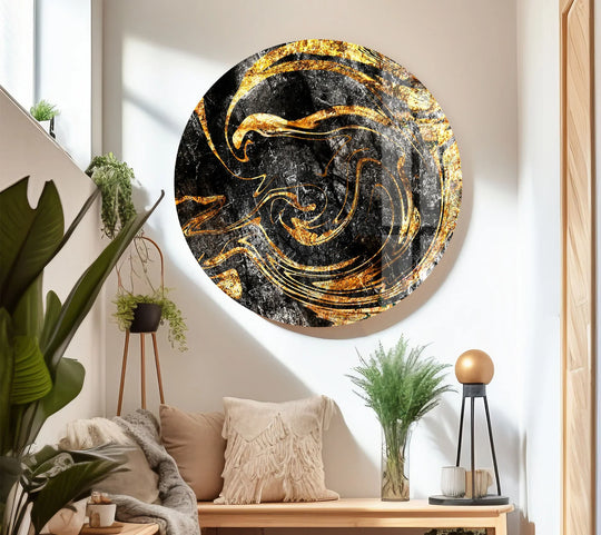 Fluid golden organic forms swirl across this black glass wall art prints, creating a luxurious marbled effect.