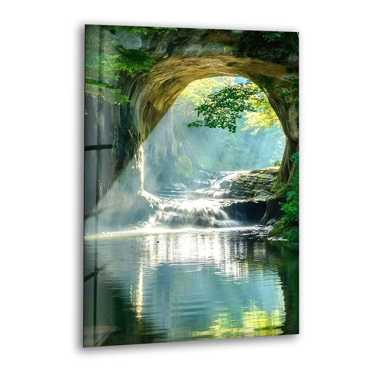 Glass wall art capturing a tranquil forest waterfall arch in serene stillness with reflected light.