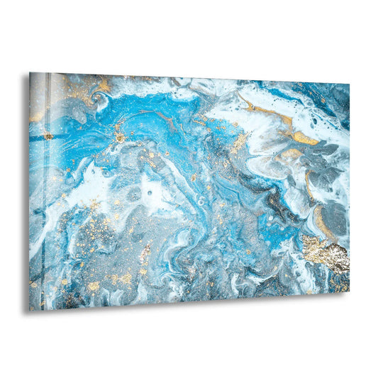 Abstract glass wall art featuring a focal point of swirling sapphire blue and white marbling with dazzling gold flecks.
