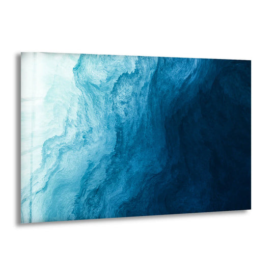 An abstract glass art print featuring fluid, wave-like geometric patterns in oceanic blues.