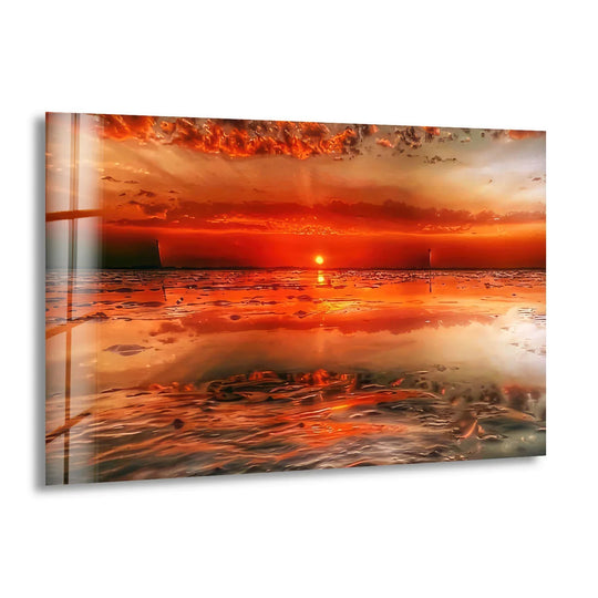 Expansive negative space defines the vibrant Fiery Sunset Shoreline hanging wall art, creating depth as the dramatic, orange-hued ocean meets the fiery sky in this vivid glass print.