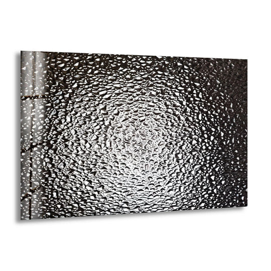 Monochrome shattered glass art for home decor displays stark contrast between light and shadow on its abstract textured surface.