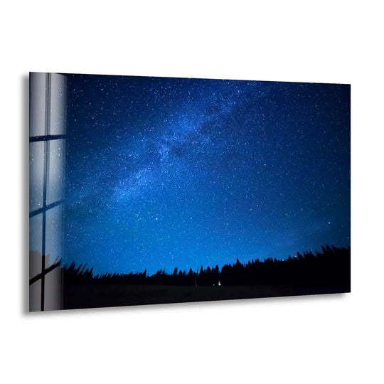 Featuring the abstract quality of a deep blue starry night sky, this milky way landscape shines as elegant glass wall art decor.