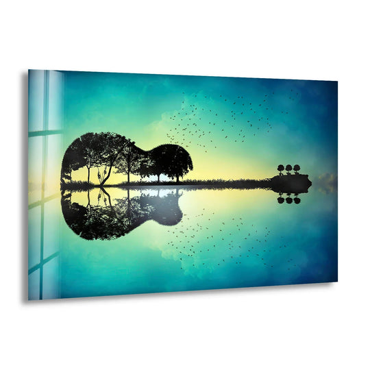 Dark silhouettes of trees form a guitar shape on a surreal island, reflected in water, as part of art from glass.