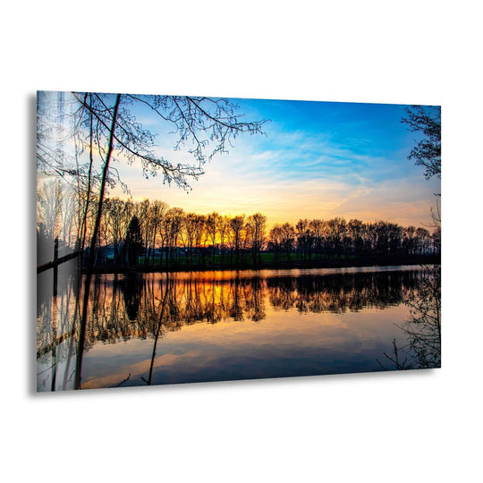 Striking color contrast defines the tranquil sunset lake glass wall art, with vivid oranges mirroring against the deep blues in this landscape wall art prints.