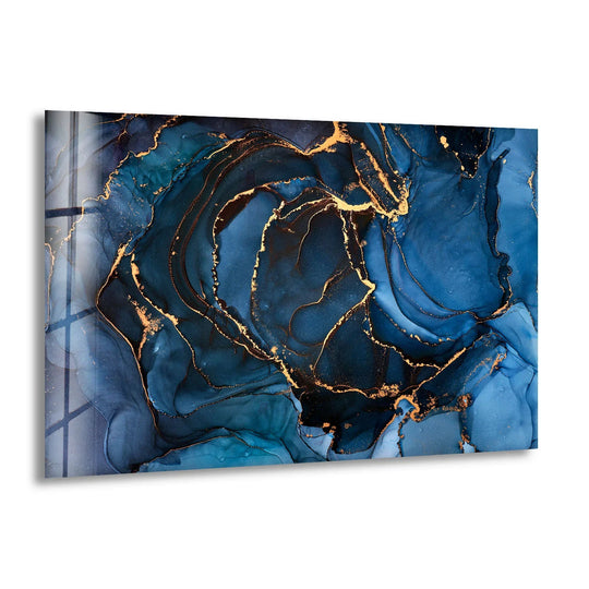 Deep navy and sapphire fluid ink layers swirl with luminous gold accents in this abstract glass wall art print.