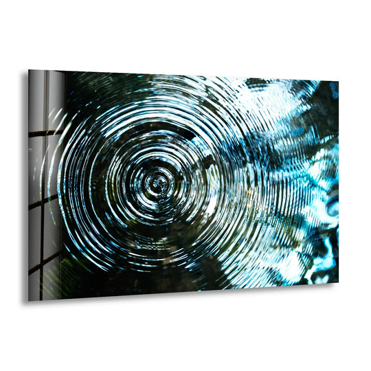 Abstract glass print wall art showcases a mesmerizing transition from dark depths to bright blue circular waves.