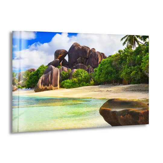 The organic forms of massive granite boulders meet lush tropical foliage in this stunning art from glass wall art, capturing the raw, untouched beauty of a beach paradise.