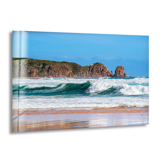 High-quality tempered glass wall art showcases the vibrant colors and crisp details of the rocky coastline and crashing ocean waves in this scenic beach print.