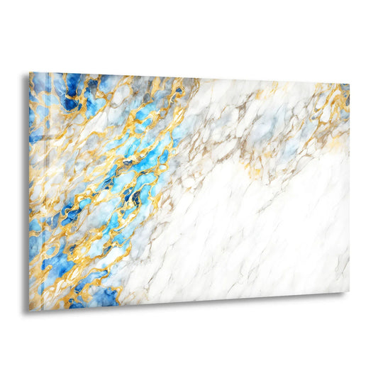 Abstract glass art with a lustrous, reflective finish showcases striking azure veins and shimmering gold accents against a white marble backdrop.