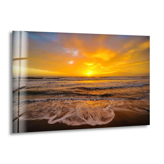 The brightest area illuminates the tempered glass print wall art, showing a golden sunset reflecting beautifully on the ocean waves.