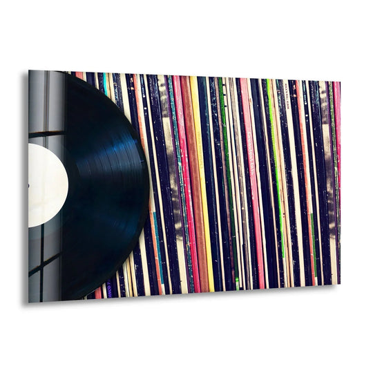 The vibrant, contrasting colors of album spines create a striking backdrop for a classic vinyl record in this decorative wall art.