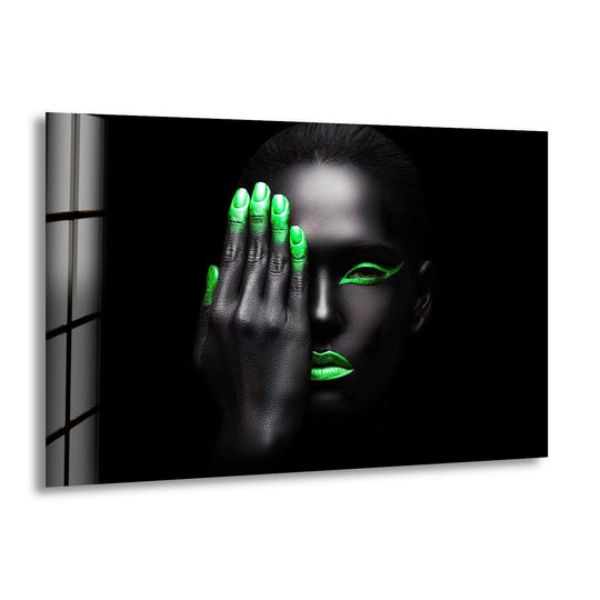 Bold glass wall artwork features a woman's face with black skin and vibrant neon green makeup.