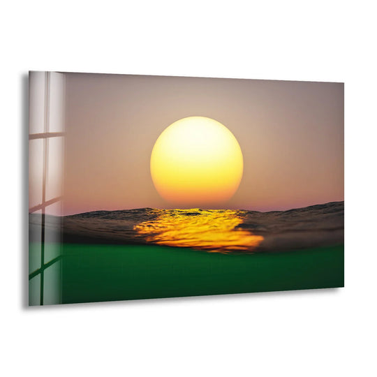 The organic forms of the golden sun and ocean waves create a mesmerizing, minimalist scene in this hanging wall art glass print.