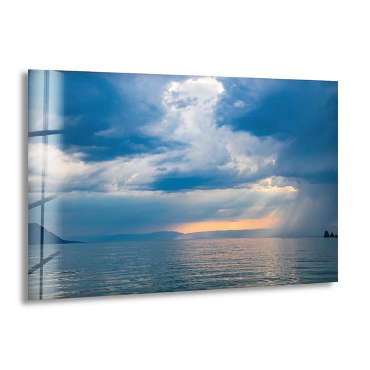 Swirling clouds and cascading sunlight give a sense of movement to this stormy ocean sunset wall art, a piece of unique modern wall decor that captures nature's moody beauty.