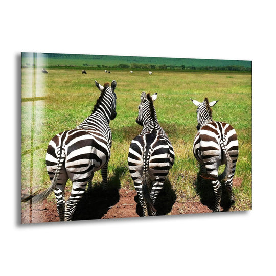 Three zebras walk across a grassy savanna, their striped bodies creating a captivating sense of depth in this best glass art.