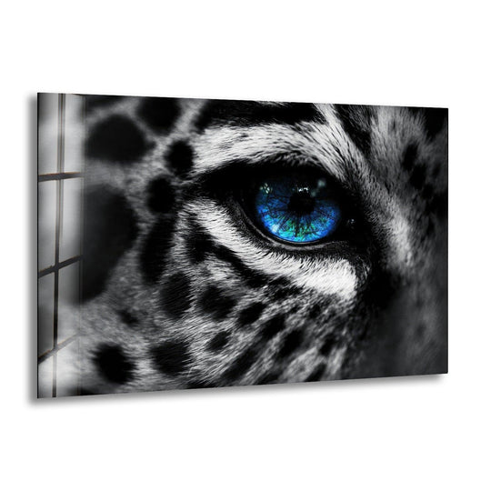 Minimalist glass wall artwork featuring the captivating, negative space surrounding a leopard's vivid blue eye.