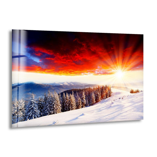 Witness the awe-inspiring home decor as the fiery sunset's vibrant reds seamlessly melt into the snowy mountain's cool blues on this glass wall art.