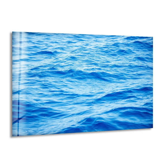 Illuminating the vibrant blue sea waves, the brightest area enhances the beauty of this captivating glass wall artwork, bringing a serene seascape to life.