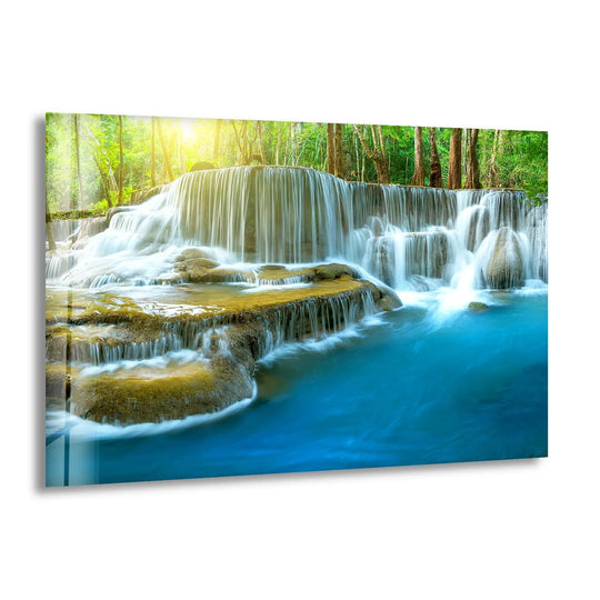 Serene waterfall glass wall art shows a tranquil cascade in nature and a lush forest scene under golden sunlight for nature inspired interiors