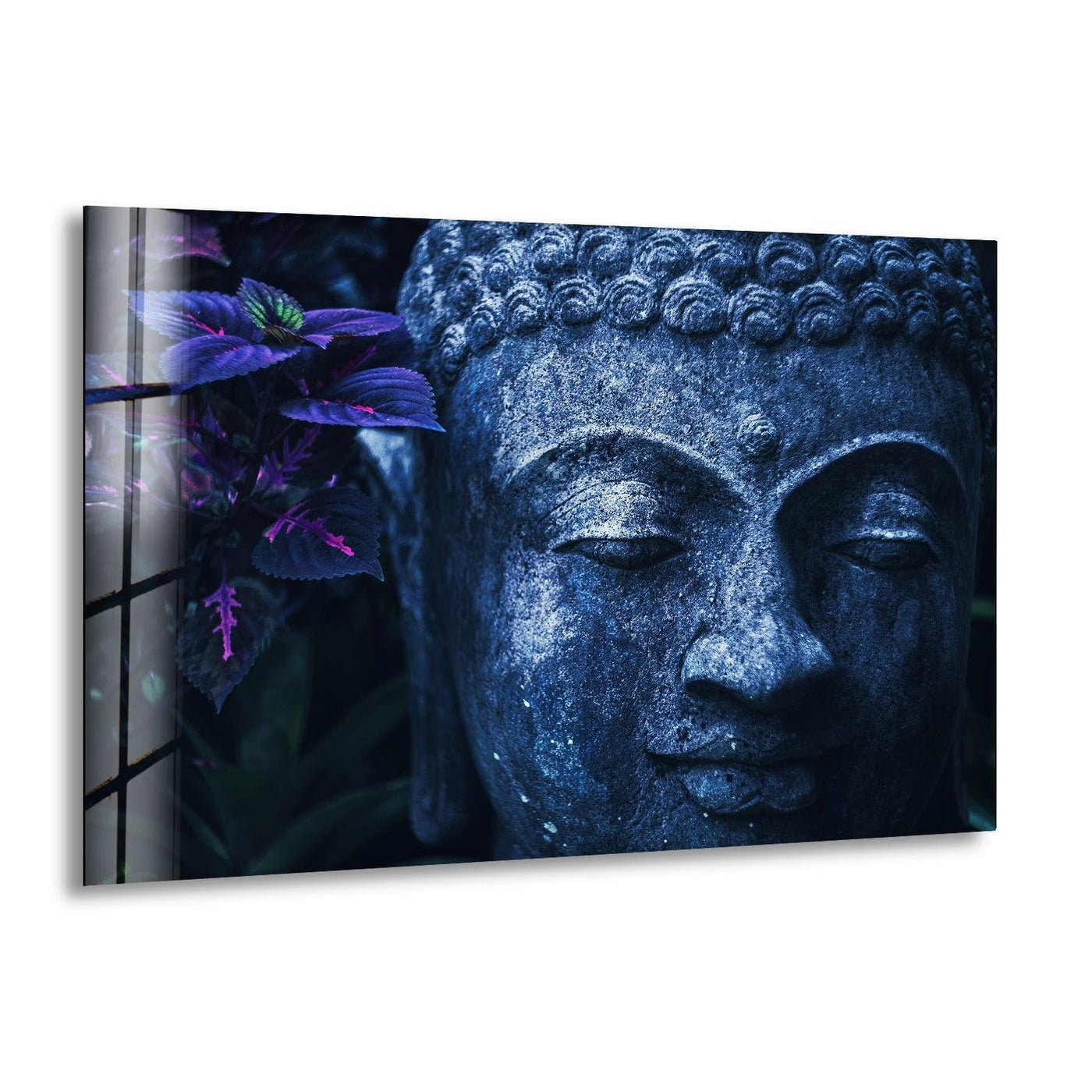 As the focal point, the serene face of a Buddha statue emerges amidst vibrant foliage in this striking blue glass wall art decor.